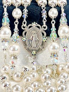 "Magnificent bridal white Austrian crystal pearl rosary made with the finest quality satin smooth Austrian pearls, Czech Preciosa bicone crystals, and silver plated embellishments on every bead. The centerpiece is the beautiful Miraculous Medal in oxidized silver and surrounded by crystals. The lovely crucifix has been crystallized by hand, but I would be happy to leave it plain without crystals if you like- just ask! This rosary is very dressy and formal, yet perfect for every Sacramental occas Wedding Rosary, Baby Baptism Gifts, Pearl Rosary, Heirloom Wedding, First Communion Gifts, Communion Gifts, Wedding Bridal Bouquets, Miraculous Medal, Catholic Gifts