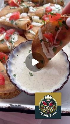 a person dipping some food into a bowl