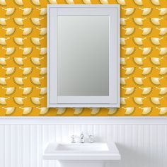 a bathroom with a sink, mirror and yellow wallpaper