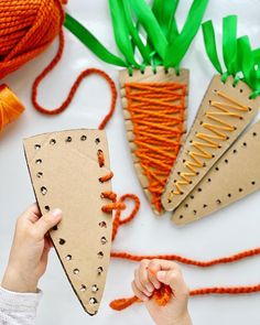 someone is making some paper carrots out of cardboard and stringing them with scissors