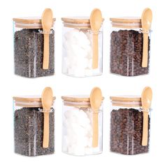 four glass jars with wooden spoons filled with coffee beans and marshmallows