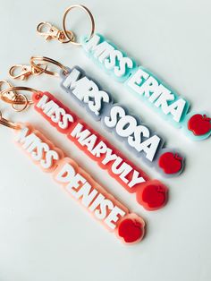 four keychains with the words miss erra, mrs sosa, ms marilyn and dentists on them