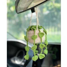 a crocheted pot holder hanging from the dashboard of a car