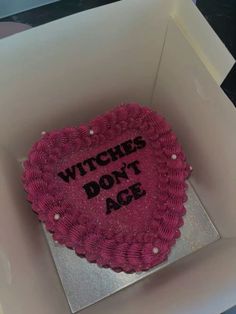 a heart shaped cake in a box with the words witches don't age written on it