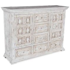 an old white dresser with many drawers