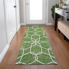 a bright green rug is on the floor in front of a white door and entryway