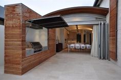 an open garage with sliding glass doors on the outside