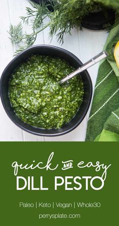 a bowl filled with pesto next to lemon wedges and green napkin on the side