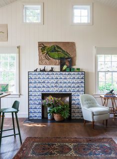 a living room filled with furniture and a fire place in front of a painting on the wall