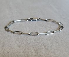 A nice understated paperclip bracelet that you can wear everyday. Made entirely out of sterling silver you have your choice of an oxidized finish or not, and clasp. ~ Solid Sterling Silver a.k.a. 925 Silver ~ 3 Finishes Available ~ Link size: 4.3mm X 10mm My go to info on how to choose a bracelet size: https://maisygracedesigns.com/apps/help-center Please note if ordering the dark oxidized finish that with handling and time the oxidation will wear away in places, giving the bracelet more of a li Paperclip Bracelet, Silver Chain Style, Necklace Length, Chain Link Bracelet, Paper Clip, Bracelet Sizes, Cute Jewelry, Earring Necklace, Silver Bracelets