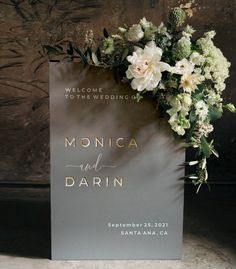 a welcome sign with flowers and greenery on it for an elegant wedding in san francisco, california