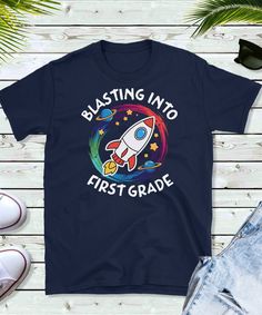 a t - shirt with the words blast into first grade on it and a rocket ship in