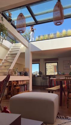 a living room filled with furniture and a skylight