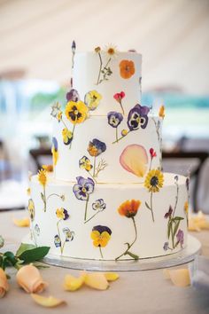 a three tiered cake decorated with colorful flowers