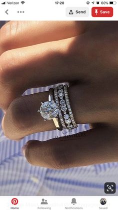 a woman's hand holding an engagement ring with two rows of diamonds on it