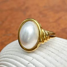 New, but old pieces, never worn, recently acquired from a premier jeweler located in Minneapolis, MN for many years- a rare opportunity! 18KT yellow Ggld genuine, bezel-set, white, oval, mabe pearl ring. Size 6.75 Sizable by us for a fee or your local jeweler Weight: 10.3 grams Band width: 3mm in back Pearl measures: 15mm x 11mm oval mabe pearl Stamped 18k By Honora Heirloom High Luster Oval Pearl Ring, Elegant White Domed Jewelry, Classic Gold Pearl Ring With High Luster, Classic Gold Pearl Ring With Polished Finish, Timeless Oval Rings With High Luster, Oval Hallmarked Gold Pearl Ring, Gold Hallmarked Oval Pearl Ring, Gold Oval Hallmarked Pearl Ring, Classic Oval Ring With High Luster