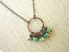 "This delicate genuine turquoise necklace is made up of five copper wire wrapped genuine green turquoise stones. They freely dangle from a 3/4\" diameter hammered copper circle. The necklace has a copper peanut link chain and a copper lobster claw clasp. Choose from 16\", 18\" or 20\". If you would like another length, please convo me. All my jewelry comes gift boxed with a bow ready for gift giving, whether it is a gift for you or someone special. Thank you for visiting Jen's Bead Box Jewelry!" Adjustable Wire Wrapped Turquoise Necklace With Round Beads, Bohemian Green Turquoise Necklace With Round Beads, Turquoise Wire Wrapped Round Necklace, Handmade Green Turquoise Dangle Necklace, Green Bohemian Dangle Turquoise Necklace, Green Bohemian Copper Wire Necklace, Bohemian Green Turquoise Dangle Necklace, Unique Turquoise Copper Necklace, Unique Wire-wrapped Turquoise Pendant Necklace