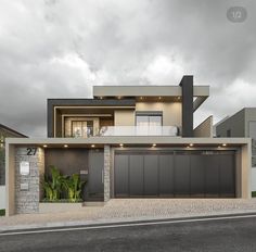 a modern house with two garages on the street