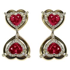 These Double Heart Shape Ruby Earrings with Diamonds in 18K Yellow Gold, part of the 'G-One' Collection, are a stunning display of elegance. These earrings showcase two heart-shaped rubies adorned with diamonds, set in 18K yellow gold. The design is both sophisticated and romantic, making it an ideal choice for adding a touch of glamour to any look. * Gemstone size: 7 x 6 mm * Gemstone: 100% Earth Mined * Approx. gemstone Weight: 4.74 Carats * 100% Natural Earth-Mined Diamonds * Carat: Approx.: 0.72 * Color: G/H * Clarity: VS * Cut: Heart * Metal: 18K Yellow Gold Diamond Earring Design, Sparkling Jewelry, Diamonds Earrings, Ruby Heart, Double Diamond, Ruby Earrings, Double Heart, Two Hearts, Ruby Diamond