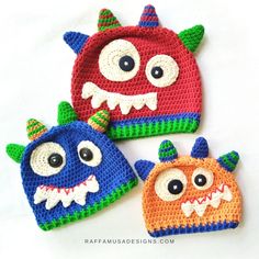 three crocheted monster hats with eyes and mouths