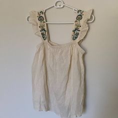 Never Worn! Lightweight Madewell Top With Frill Shoulders With Embroidered Details. Loved This Shirt But Never Found A Way To Incorporate It Into My Style. Embroidered Off White Summer Tops, Off White Embroidered Summer Tops, Cream Floral Embroidered Summer Tops, Cute Embroidered Tops For Vacation, Sleeveless Embroidered Tops For Brunch, Casual Embroidered Off White Tops, Summer Cotton Off White Blouse, Summer Off-white Cotton Blouse, Summer Off White Cotton Blouse