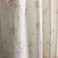 a white curtain with pink flowers on it