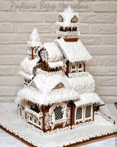 a gingerbread house is decorated with icing and snow