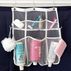 an organized travel bag hanging on a wall with toiletries and hand soaps in it