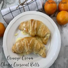 orange cream cheese crescent rolls on a white plate