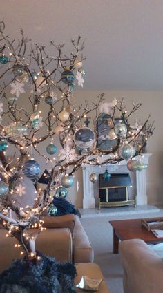 a living room filled with furniture and a christmas tree in the middle of the room