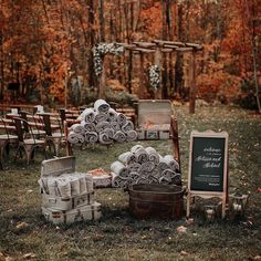 an outdoor ceremony setup with chairs and signs