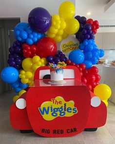 the wiggles ice cream cart is decorated with balloons