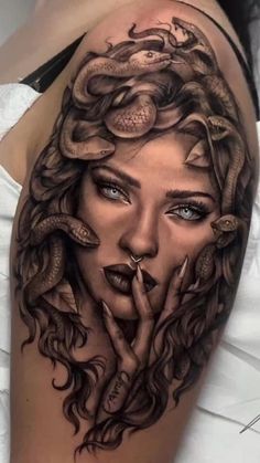 a woman's face with snakes on her head and hands in the shape of a snake