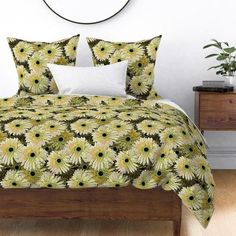 a bed with white and yellow flowers on it