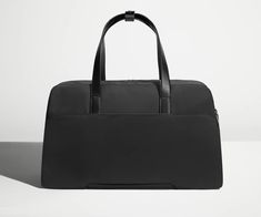 The Weekender | Away: Built for Modern Travel Functional Business Travel Accessories With Luggage Sleeve, Versatile Rectangular Travel Accessories For Business Trips, Functional Rectangular Luggage For Work, Versatile Business Luggage With Sleeve, Versatile Business Trip Luggage With Sleeve, Versatile Luggage With Top Carry Handle, Versatile Business Luggage, Rectangular Weekender Bag With Reinforced Handles For Travel, Black Duffle Bag With Reinforced Handles For Travel