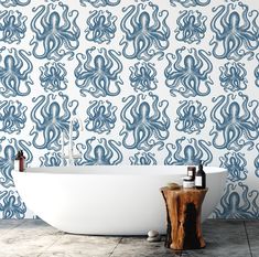 an octopus wallpaper in a bathroom with a claw foot bathtub and wooden stool