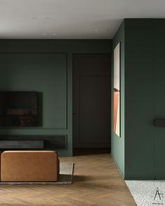 an empty living room with green walls and wood flooring is pictured in this image