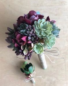 the bridal bouquet is made with succulents and tied in twine