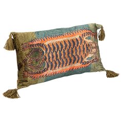 a decorative pillow with an animal design on the front and tasselled fringes