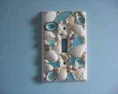 a light switch cover with shells and seashells on it