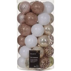 a glass container filled with white and gold christmas bauble ornament balls