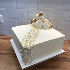 a cake with white frosting and gold decorations