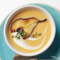 a white bowl filled with soup on top of a blue plate