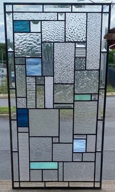 a large stained glass window sitting on the side of a road