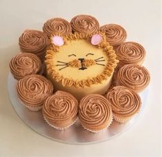 a cake with icing that looks like a lion's face in the center