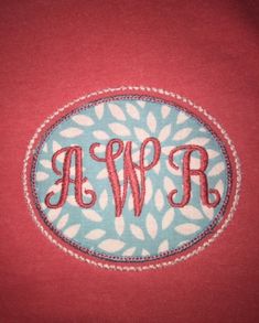 an embroidered monogrammed shirt with the word's initials in red and blue