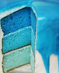 a blue and green cake with white frosting