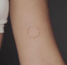 a woman's arm with the word tattoo on it