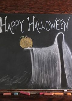 a chalkboard drawing of a ghost with a pumpkin on it