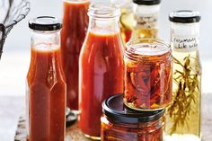 several jars filled with different types of sauces and condiments on a table